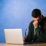 Suspicious man analyzing fake profiles